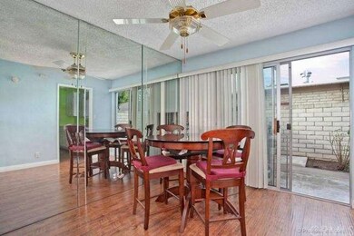 Casual dining room features ceiling fan, mirrored 