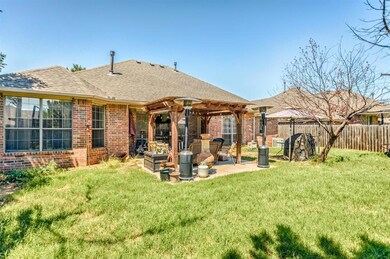 Rear view of house featuring a patio, a pergola, a