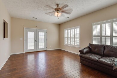 Florida room has lots of windows.  The Plantation Shutters are a nice touch to the space.  French doors lead you to the patio.