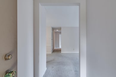 Hallway with baseboards and carpet floors