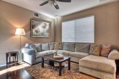 Living room with a ceiling fan and surround sound 