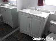 Bathroom featuring vanity, independent washer and dryer, and a shower