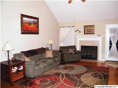 Huge great room with hardwood flooring, vaulted ceiling and fireplace!