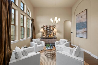 Sitting room with wood finished floors, arched wa