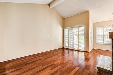 Empty room with dark wood-style flooring, baseboar