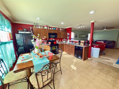 Dining space with ornamental molding, sink, plenty