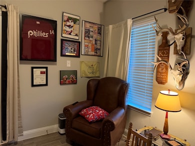 Living area with wood finished floors and baseboards