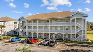 View of building exterior with uncovered parking