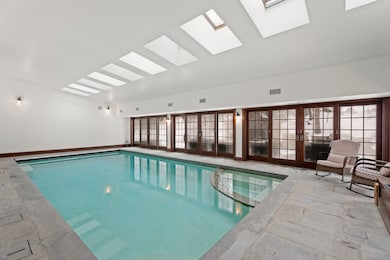 Heated indoor Gunite pool and spa with retractable cover.