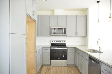 Kitchen featuring stainless steel appliances, gra