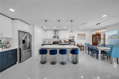 Kitchen with light countertops, wall chimney exhau