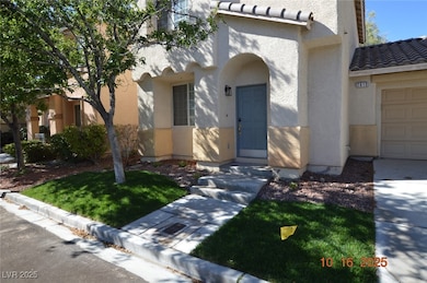 View of front of property with a tile roof, a front lawn, and stucco siding