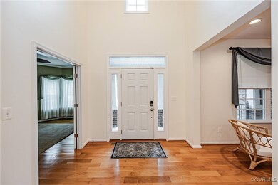 Entrance foyer featuring a towering ceiling and li