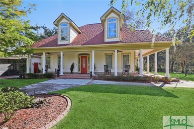 Wrap around porch w/ columns frames the home, whic