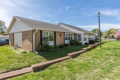 View of front of home featuring brick siding, a sh