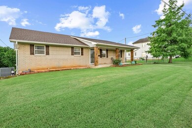 View of front of house with brick siding and roof with shingles