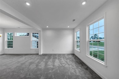 Carpeted spare room with recessed lighting