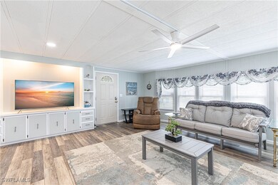 Living room featuring built in shelves, a textured