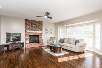 Great room with triple bay window and floor-to-cei