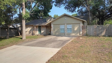 View of front of home with stone siding and driveway