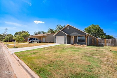Ranch-style home with a garage and a front lawn
