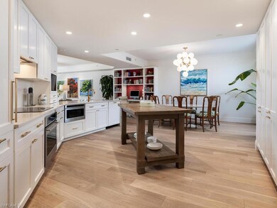 Kitchen featuring white dishwasher, black electric cooktop, light countertops, stainless steel oven, and white cabinetry