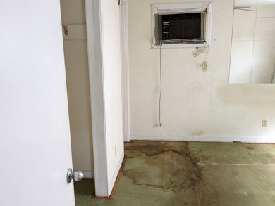 Primary bedroom has hardwood floors under the carp