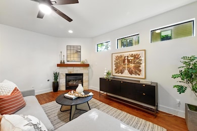 Living room with ceiling fan, wood finished floor