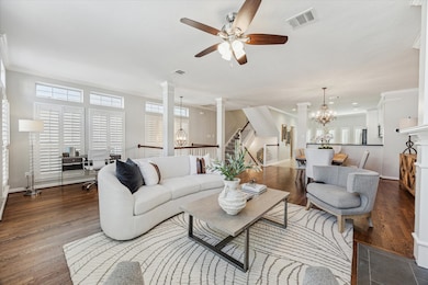 This open-concept living space features elegant ha