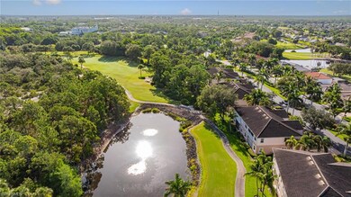 Aerial view of residential area with a nearby body of water and a golf course