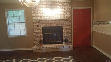Entering this cozy brick home with fireplace
