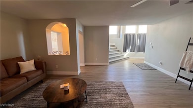 Living room featuring stairs, baseboards, a ceilin
