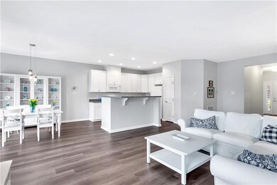The open floor plan includes a media area, dining 
