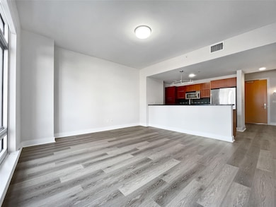 Unfurnished living room featuring light wood-styl
