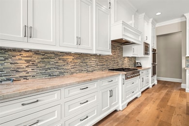 This modern kitchen features sleek white cabinetry