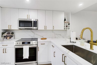 Kitchen featuring light stone counters, appliances