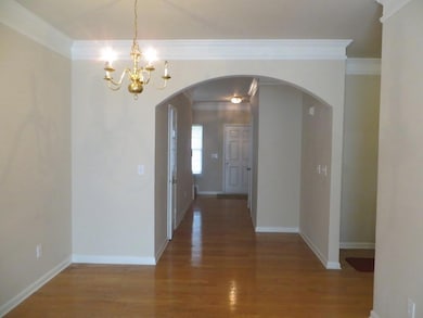 Unfurnished dining area with an inviting chandelie