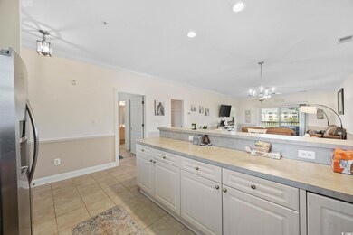 Kitchen with stainless steel fridge with ice dispenser, open floor plan, light countertops, white cabinets, and a chandelier