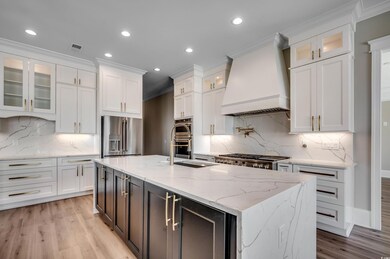 Kitchen with stainless steel appliances, white cab