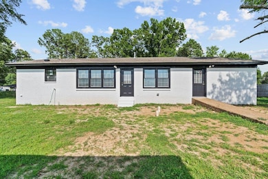 Ranch-style home featuring brick siding and a front lawn