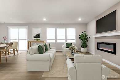 Spacious great room with cozy fireplace. Photo is representational. Actual home is under construction and materials, colors, and finishes will vary. See site agent for details.