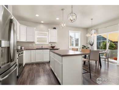 Kitchen features large eat in island and stainless steel appliances