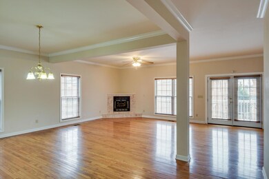 Combination living and formal dining room area featuring gas log fireplace
