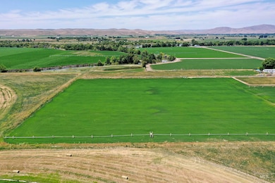 View of rural area featuring abundant farmland and a mountainous background