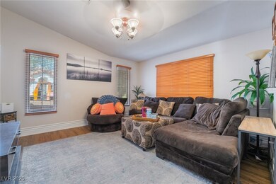 Living area with baseboards, a notable chandelier,