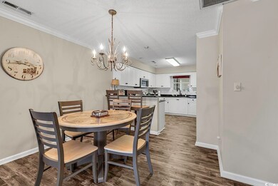 Dining area featuring dark wood-type flooring, vis