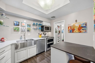 Updated with Kraus farmhouse sink, quartz countertops.