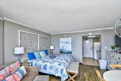 Bedroom with white refrigerator, dark tile pattern