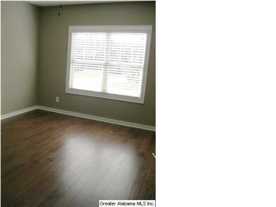 Main level second bedroom with hardwoods.