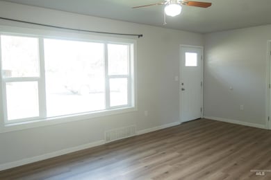 Entryway with wood finished floors and ceiling fan
